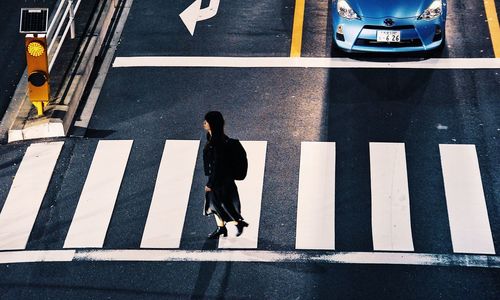 High angle view of man walking on road