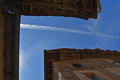 Directly below view of vapor trail over houses in alto malcantone