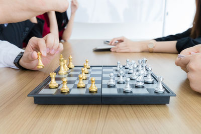 Midsection of man playing guitar on table