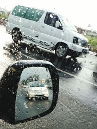 Close-up of wet car on road