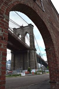 Low angle view of bridge against sky in city