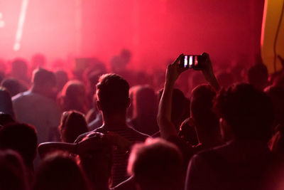 Crowd of people clubbing at live concert at music festival