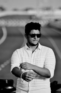 Young man wearing sunglasses standing outdoors