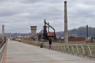 View of factory against cloudy sky