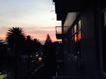 Buildings in city at sunset