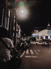 Cars on city street at night