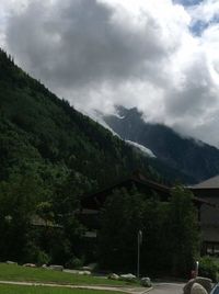 Scenic view of mountains against cloudy sky