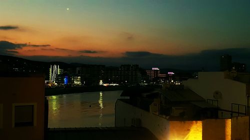 High angle view of illuminated buildings against sky during sunset