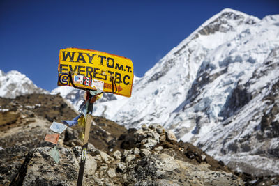 Information sign on rock against sky