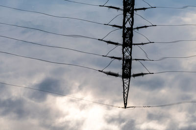 Low angle view of electricity pylon against sky