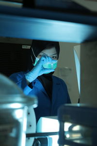 A chemical worker is testing chemicals carefully in the laboratory