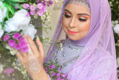 Portrait of young woman with bouquet