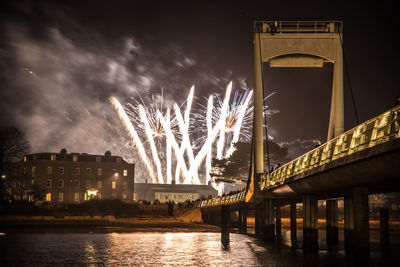 Low angle view of illuminated bridge against sky at night