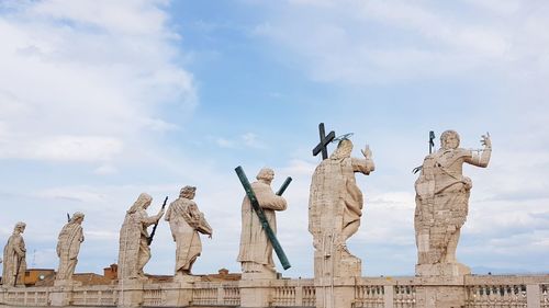 Low angle view of statues against sky