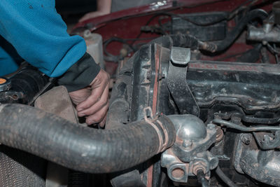 Midsection of man repairing car