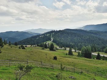 Scenic view of farm against sky