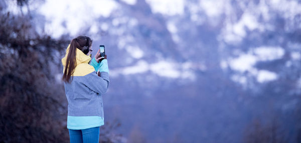 Low angle view of woman standing against sky