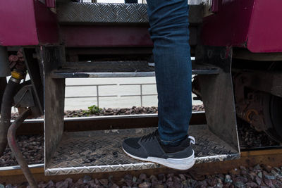 Low section of man working at bus