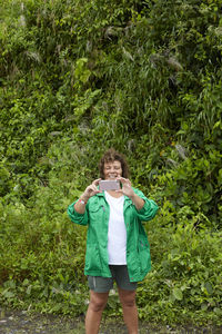 Woman taking a picture in front of the camera