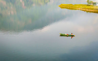 People paragliding in lake