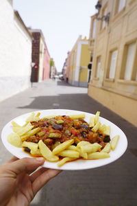 Cropped image of person holding food