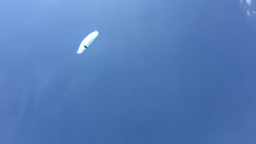 Low angle view of kite flying against clear blue sky