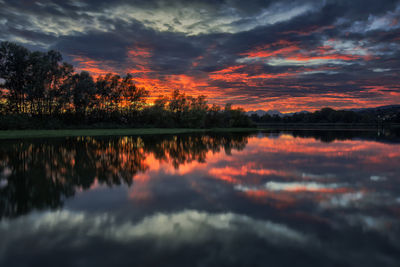 Scenic view of lake against orange sky