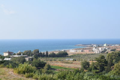 View of townscape by sea against clear sky