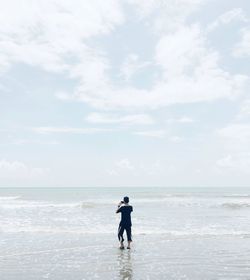 Full length of man on beach against sky