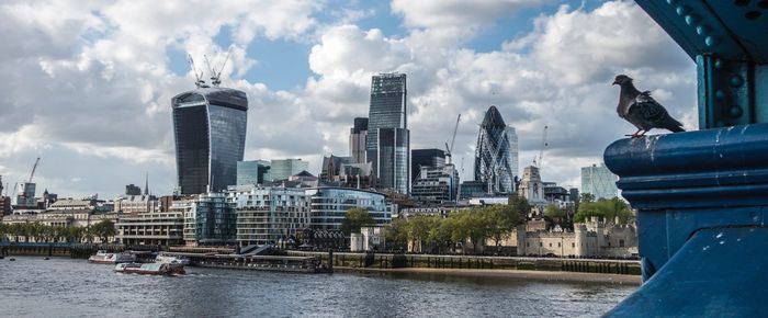 View of cityscape against cloudy sky