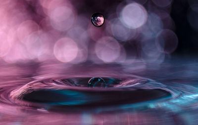 Close-up of water drop on glass table