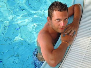 Portrait of shirtless man in swimming pool