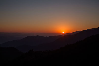 Scenic view of silhouette mountains against sky during sunset