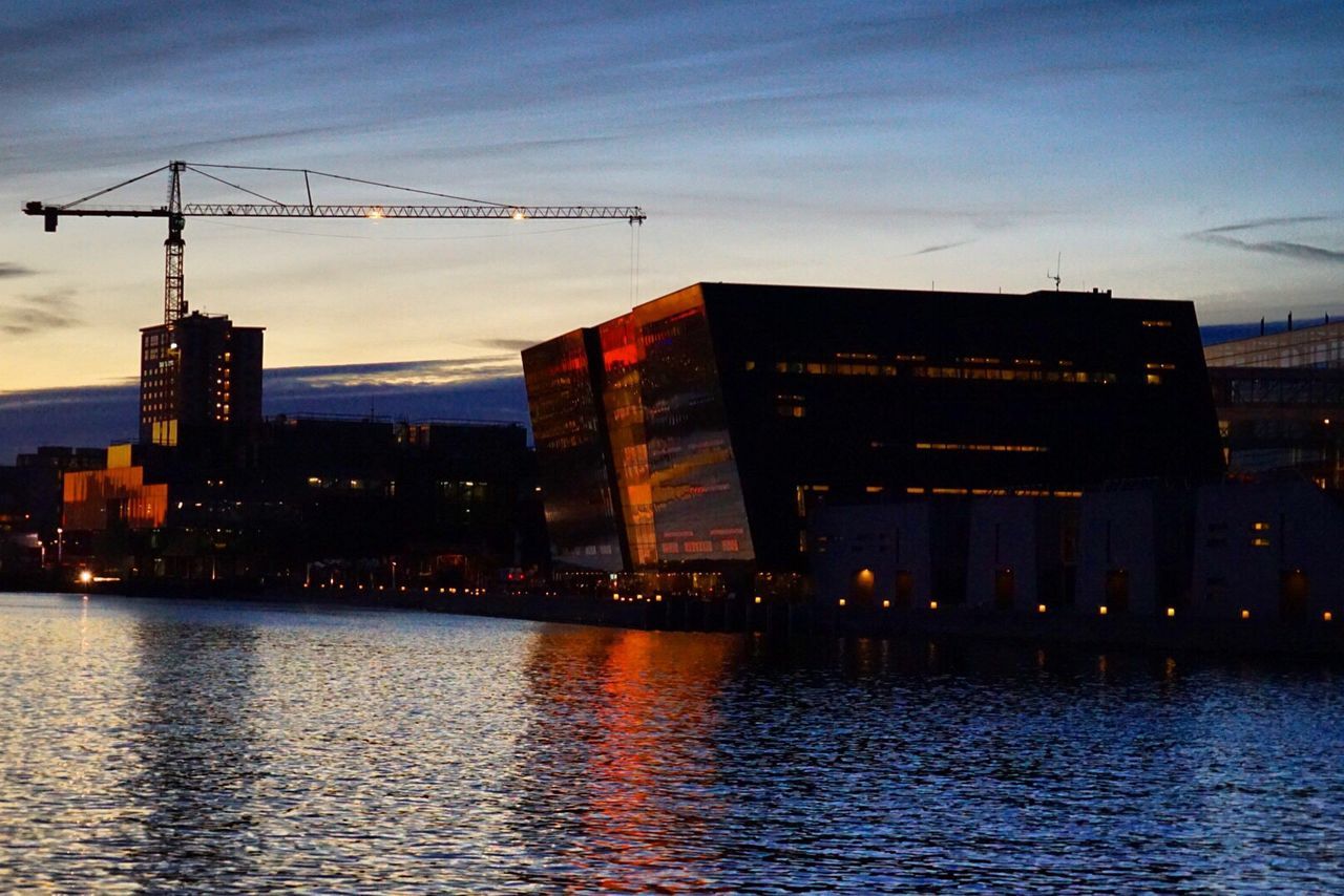 ILLUMINATED CITY AT WATERFRONT