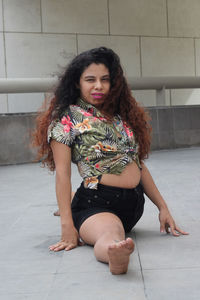 Portrait of woman doing splits on floor