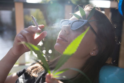 Close-up of woman holding cigarette