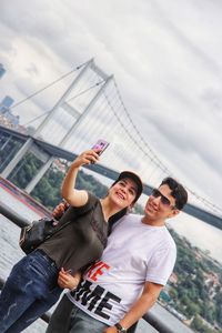 Full length of young couple taking a selfie 