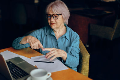 Senior woman working at cafe