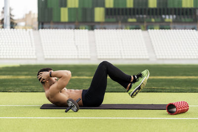 Full length of man exercising on ground