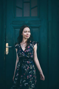 Cheerful optimistic brunette in a flower dress on the street