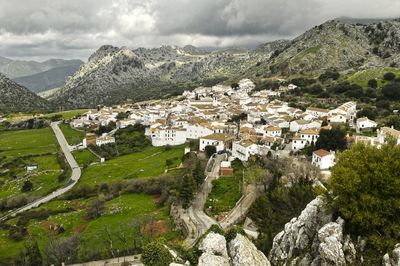 Panoramic view of townscape and mountains against sky