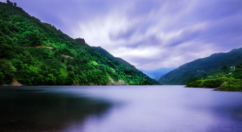 Scenic view of lake and mountains against sky