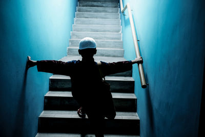 Rear view of boy walking on steps