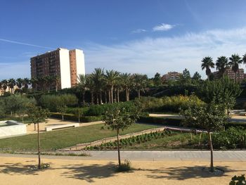 View of building by trees against sky