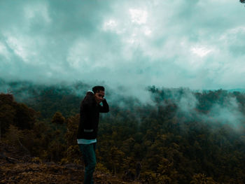 Full length of man standing on land against sky