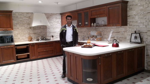 Woman standing in kitchen at home