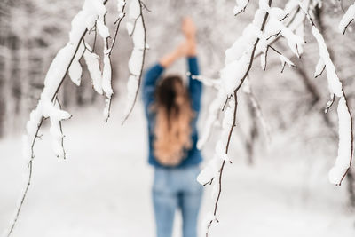 Close-up of woman standing on snow covered land