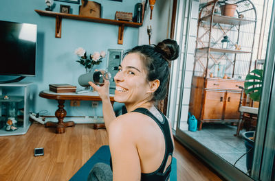 Side view of woman exercising in gym