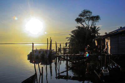 Boats in river at sunset