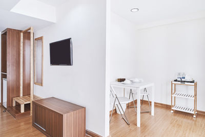 Empty chairs and tables on hardwood floor at home